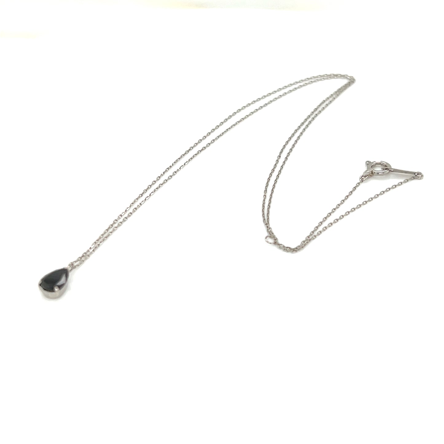 Necklace with a teardrop-shaped black diamond pendant on a white background