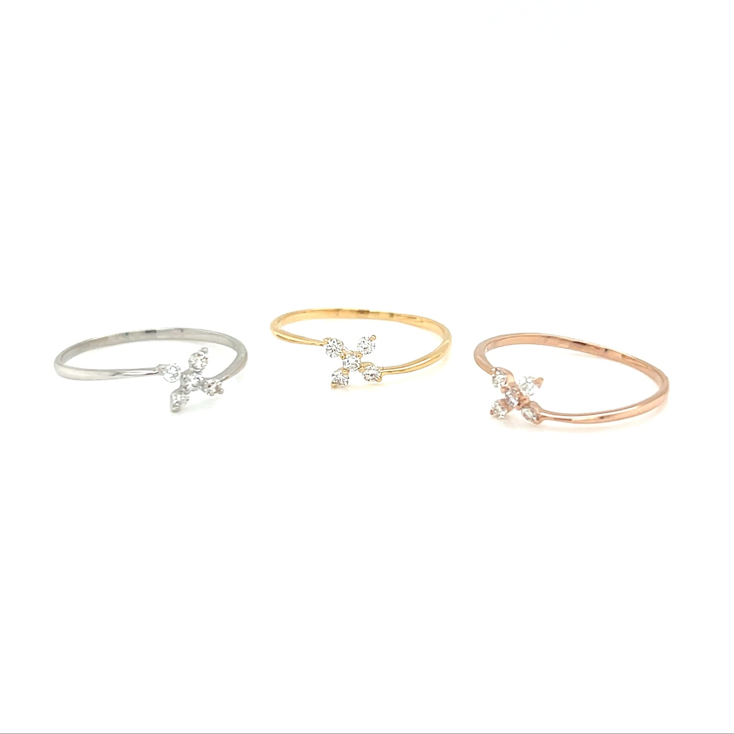 Three delicate bracelets in silver, gold, and rose gold on a white background