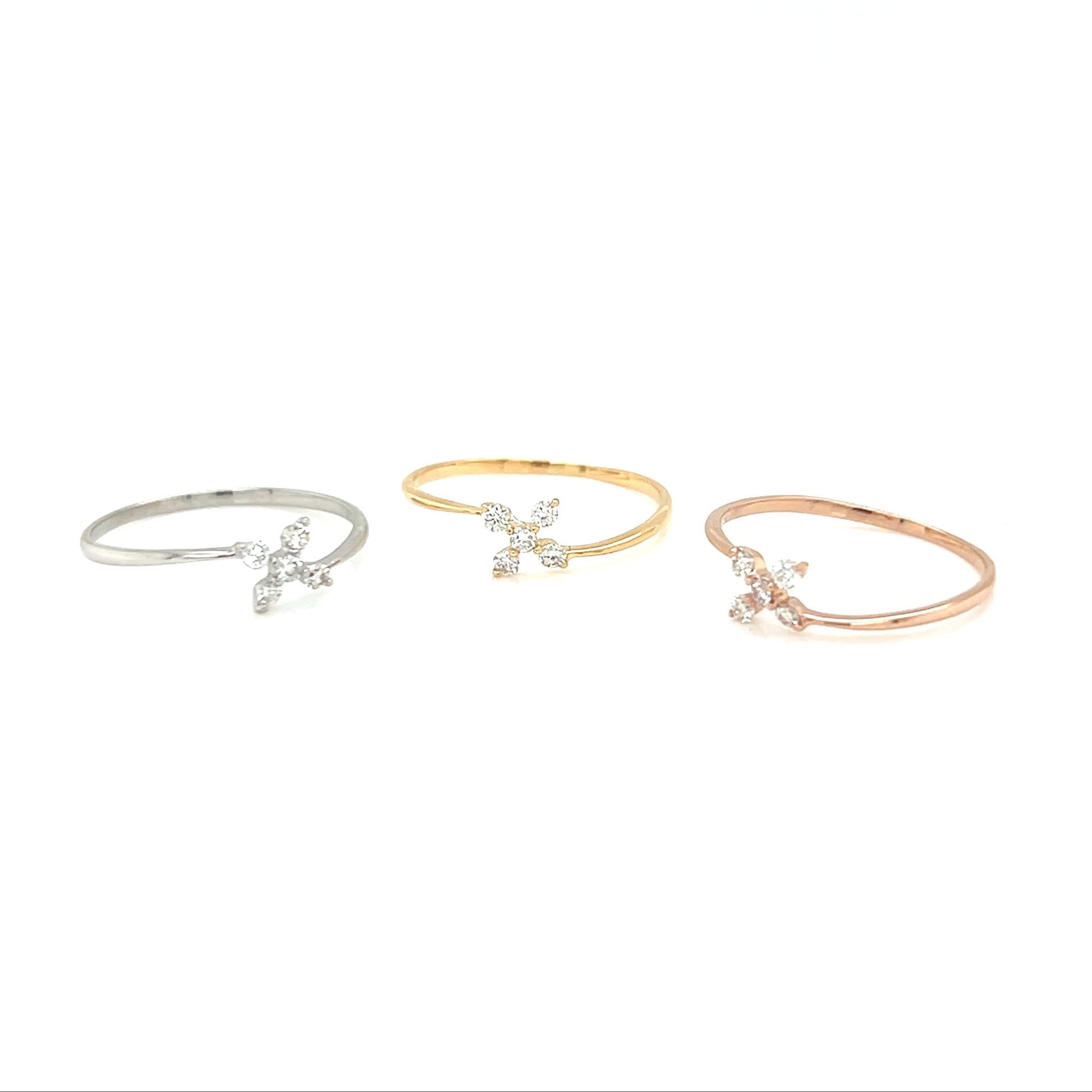 Three delicate bracelets in silver, gold, and rose gold on a white background