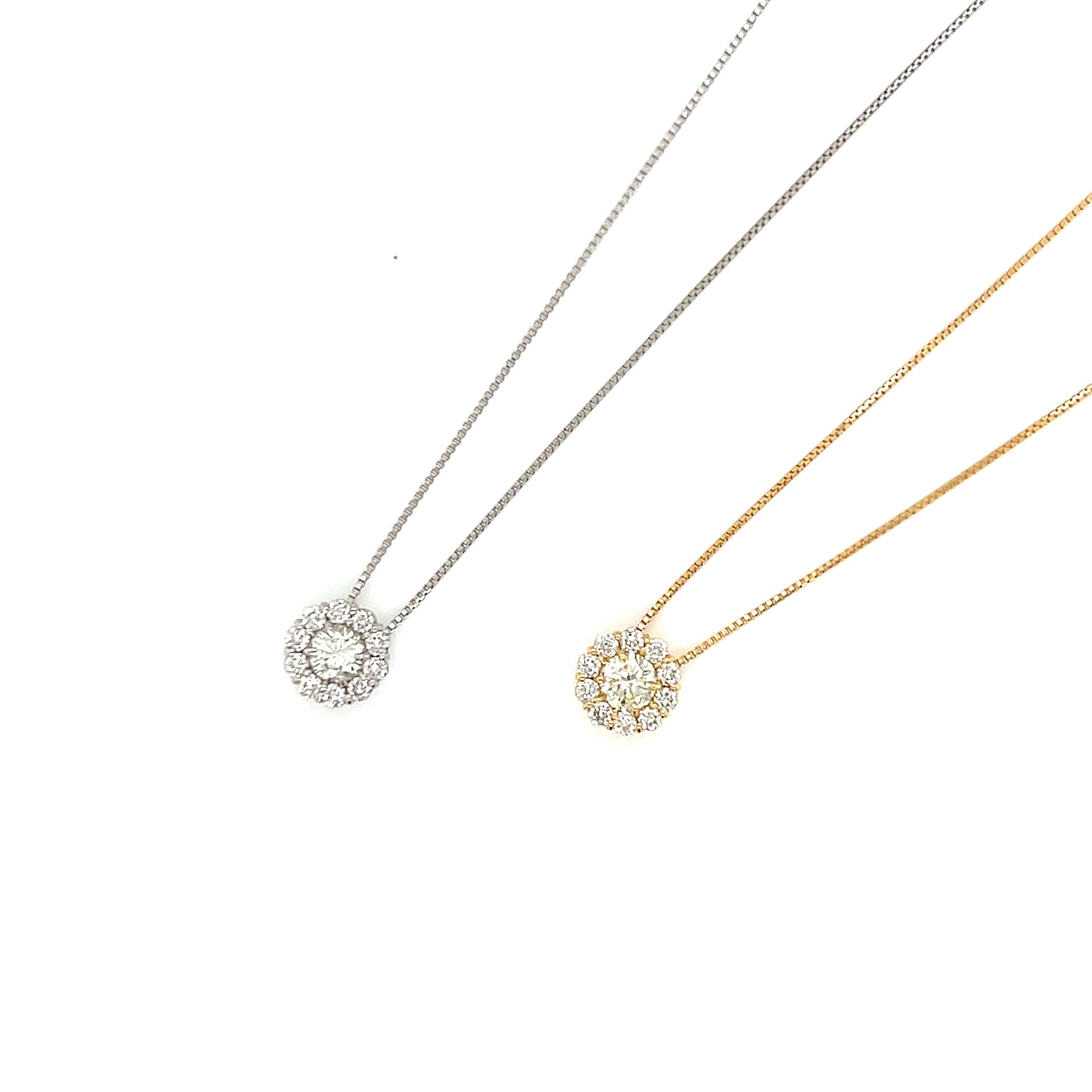 Two necklaces in white and yellow gold with circular pendants on white background