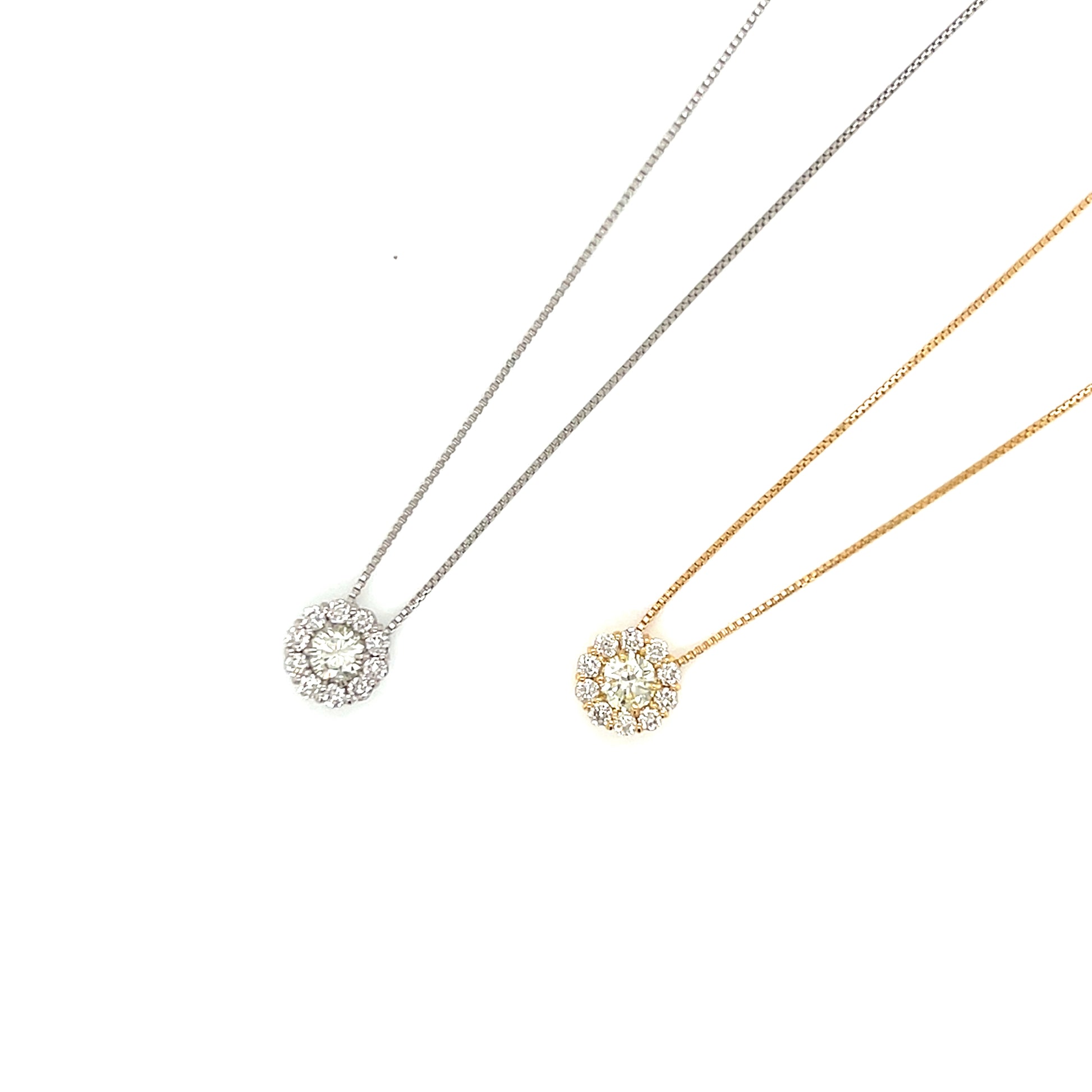 Two necklaces in white and yellow gold with circular pendants on white background