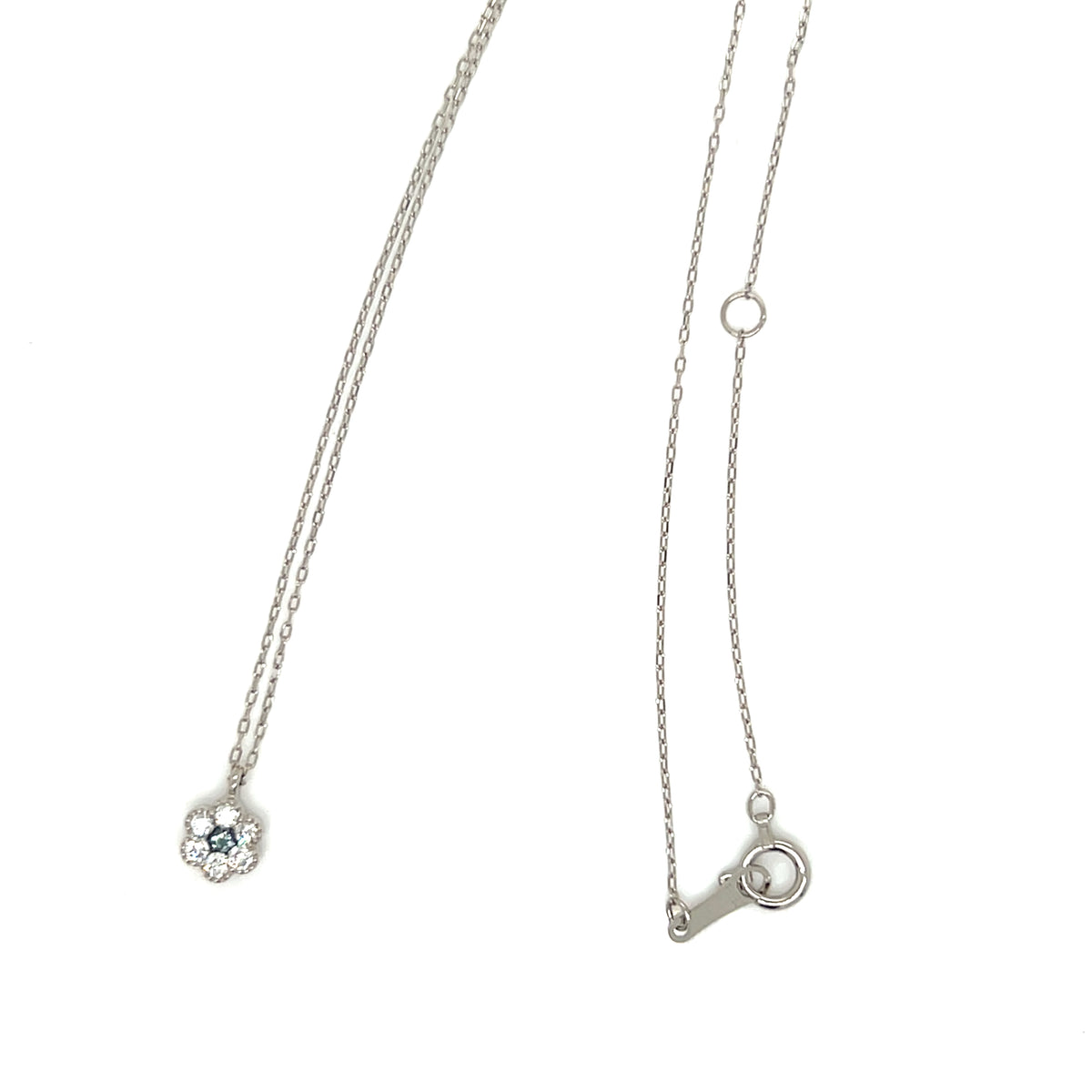 A silver chain necklace shown from two angles on a plain white background: one view displays a small floral pendant with a light blue gemstone, and the other shows the adjustable clasp end of the necklace.