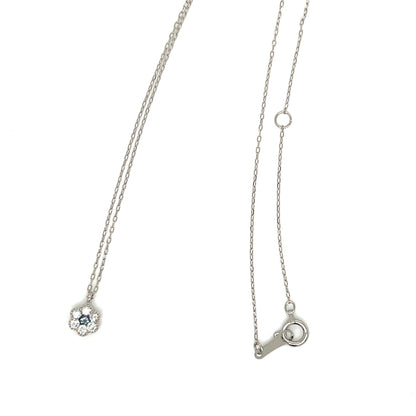 A silver chain necklace shown from two angles on a plain white background: one view displays a small floral pendant with a light blue gemstone, and the other shows the adjustable clasp end of the necklace.