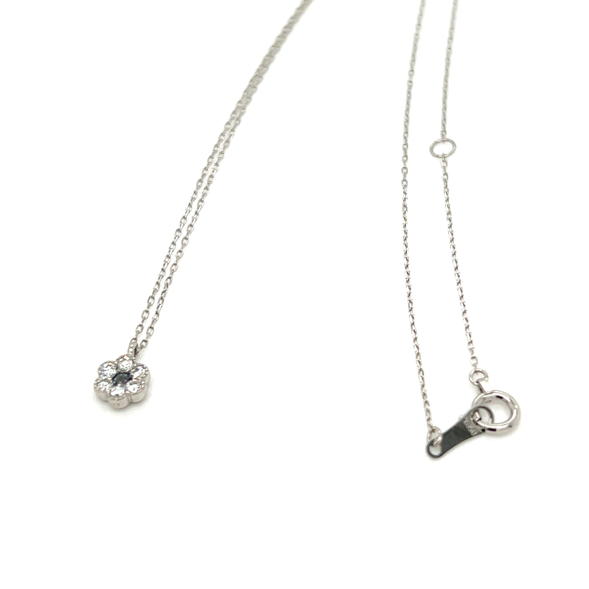 A delicate silver chain necklace featuring a small flower-shaped pendant with a clear central gemstone and a matching silver lobster clasp, displayed on a clean white background.