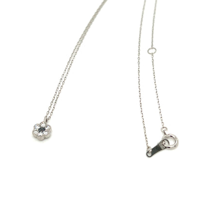 A delicate silver chain necklace featuring a small flower-shaped pendant with a clear central gemstone and a matching silver lobster clasp, displayed on a clean white background.