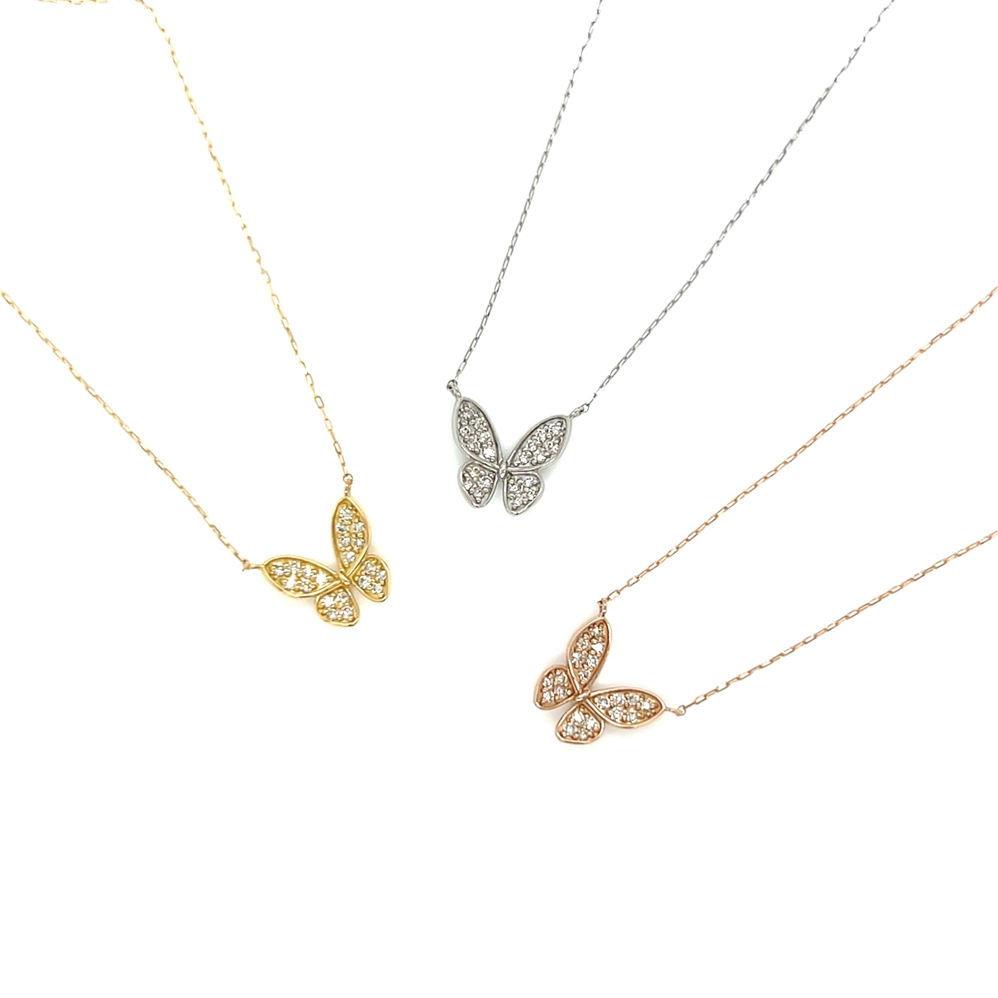 Three butterfly-shaped necklaces in gold, silver, and rose gold on a white background.