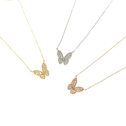 Three butterfly-shaped necklaces in gold, silver, and rose gold on a white background.