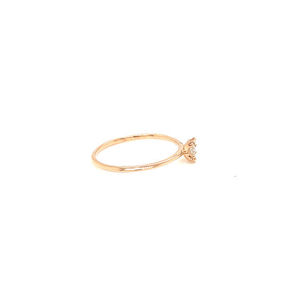 Gold ring with a small diamond on a white background
