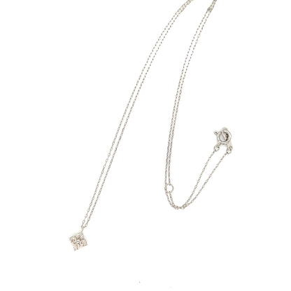 Platinum necklace with a delicate clover pendant on a white background