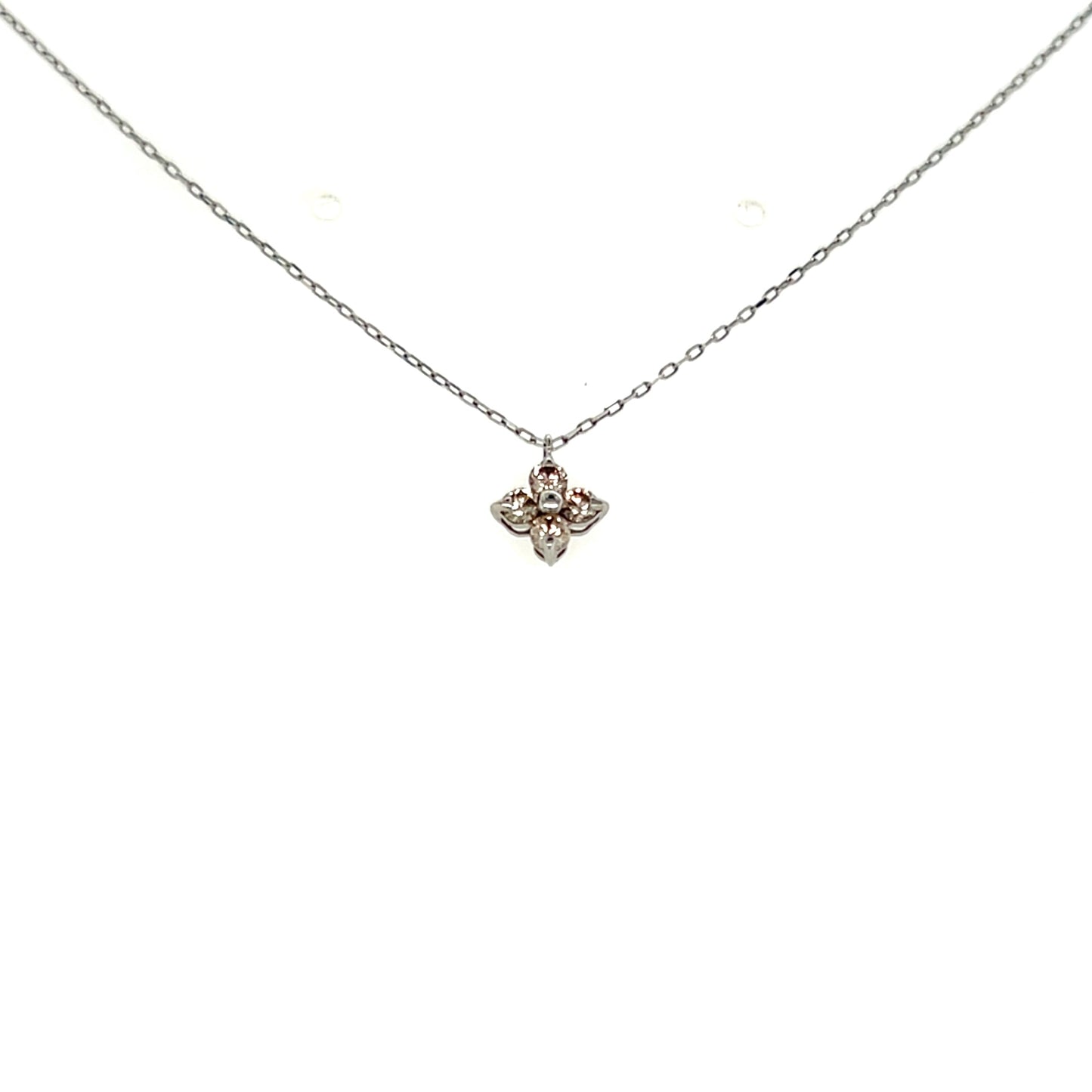 Platinum necklace with a small flower pendant on a white background