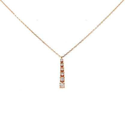Rose gold necklace with a small pendant on a white background
