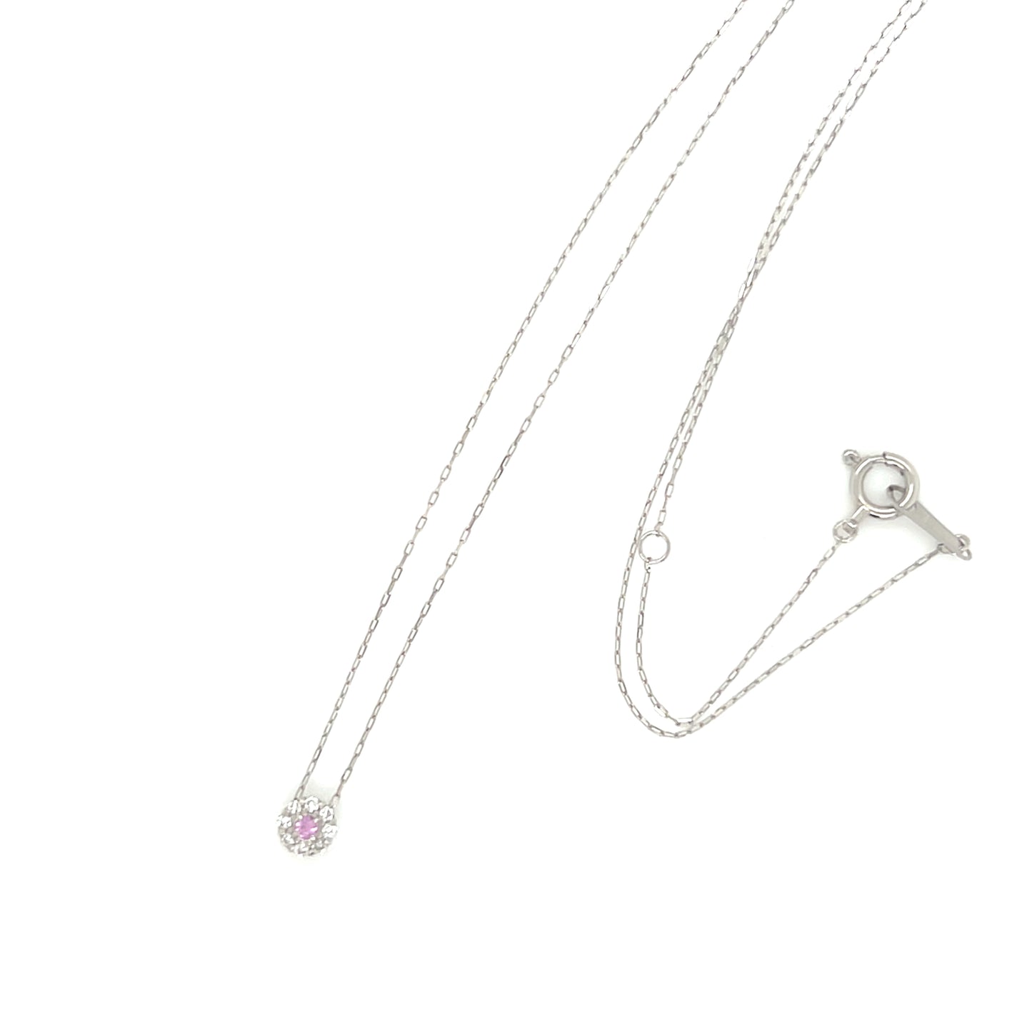 Pink sapphire halo necklace with diamond pendant on a white background