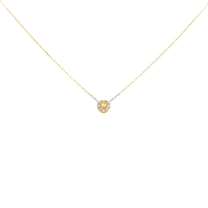 Gold necklace with a small round pendant on a white background