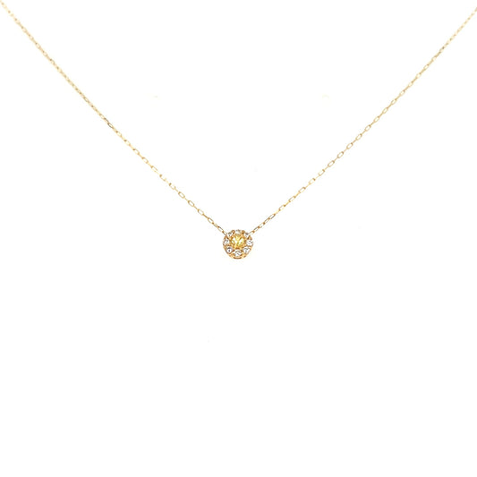 Gold necklace with a small round pendant on a white background