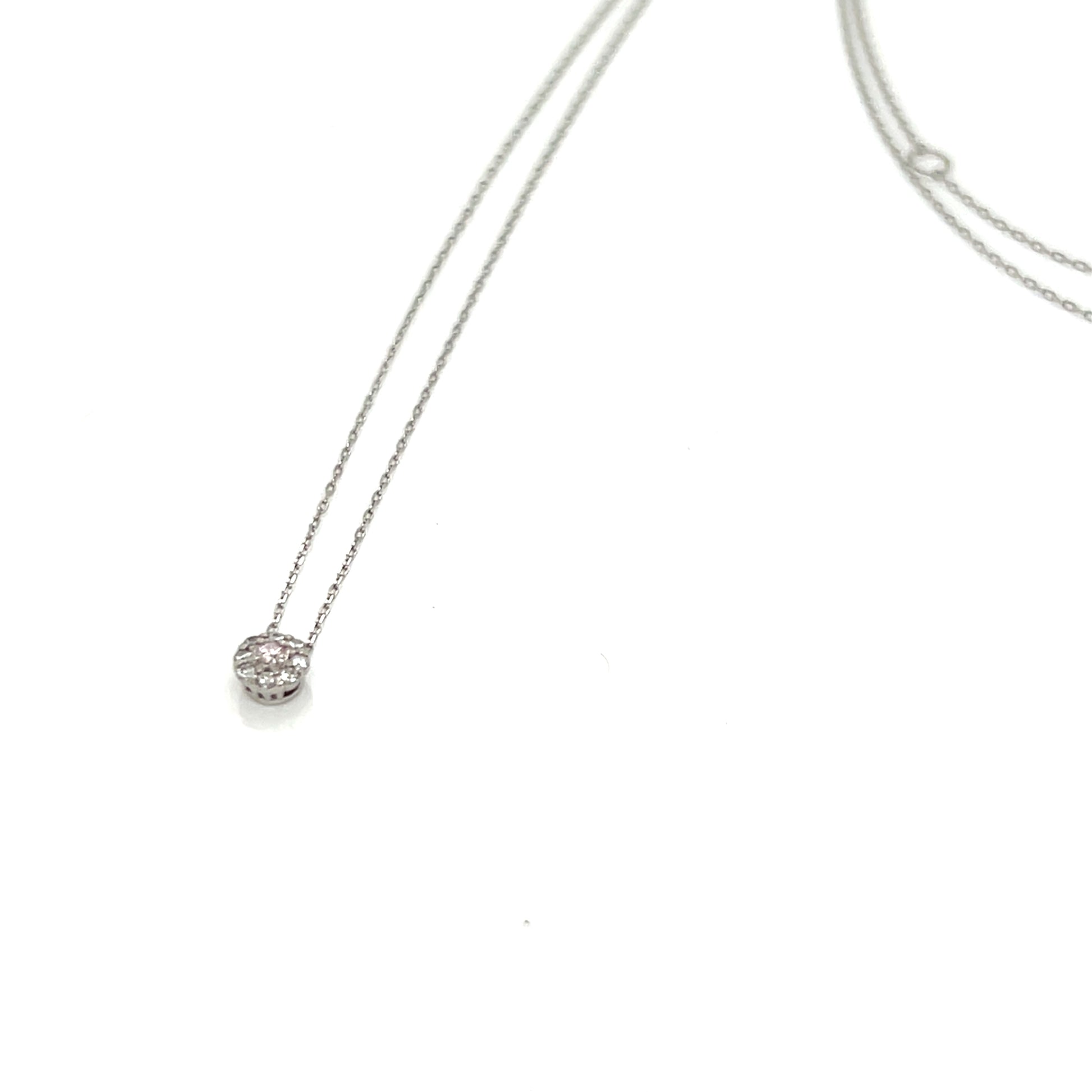 Platinum necklace with a small round Diamond pendant on a white background