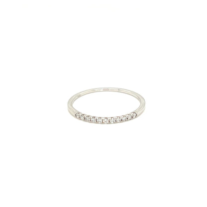 A thin silver band ring featuring a row of small clear gemstones set along the front half, photographed against a solid white background.
