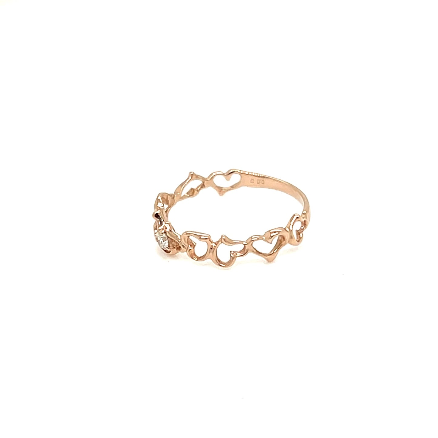 A delicate rose gold ring featuring a continuous line of small, open heart charms, displayed on a clean white background.