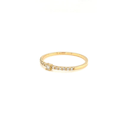 Gold ring with small diamonds on a white background