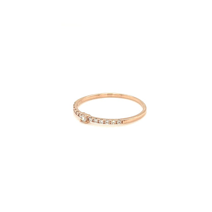 Rose gold ring with small diamonds on a white background