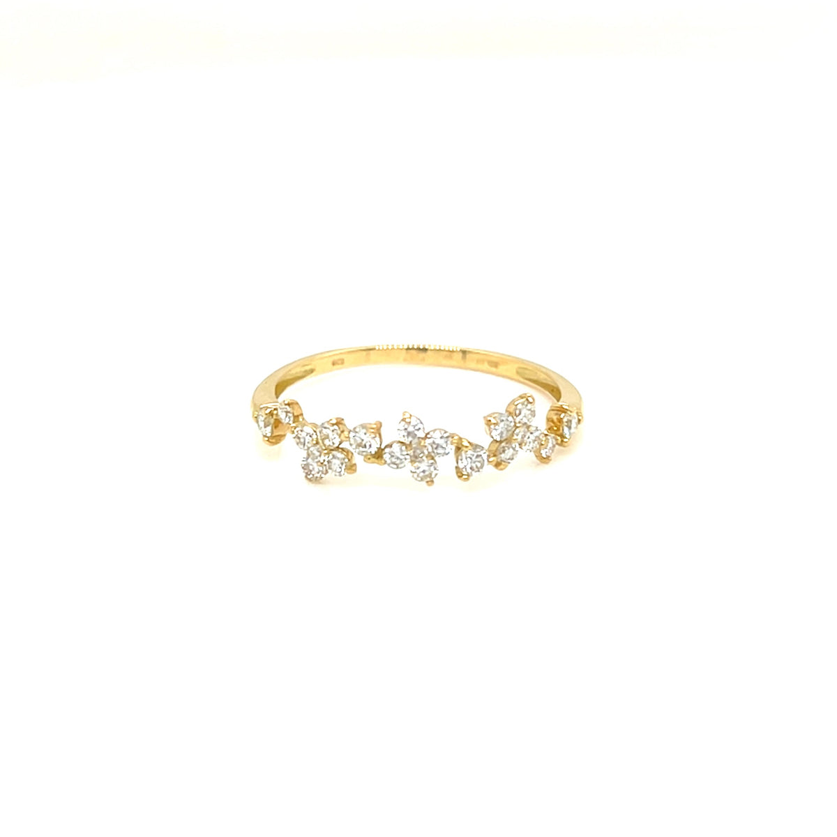 A delicate yellow gold ring featuring a row of small clear gemstones in a floral or leaf-like cluster design, set against a plain white background.