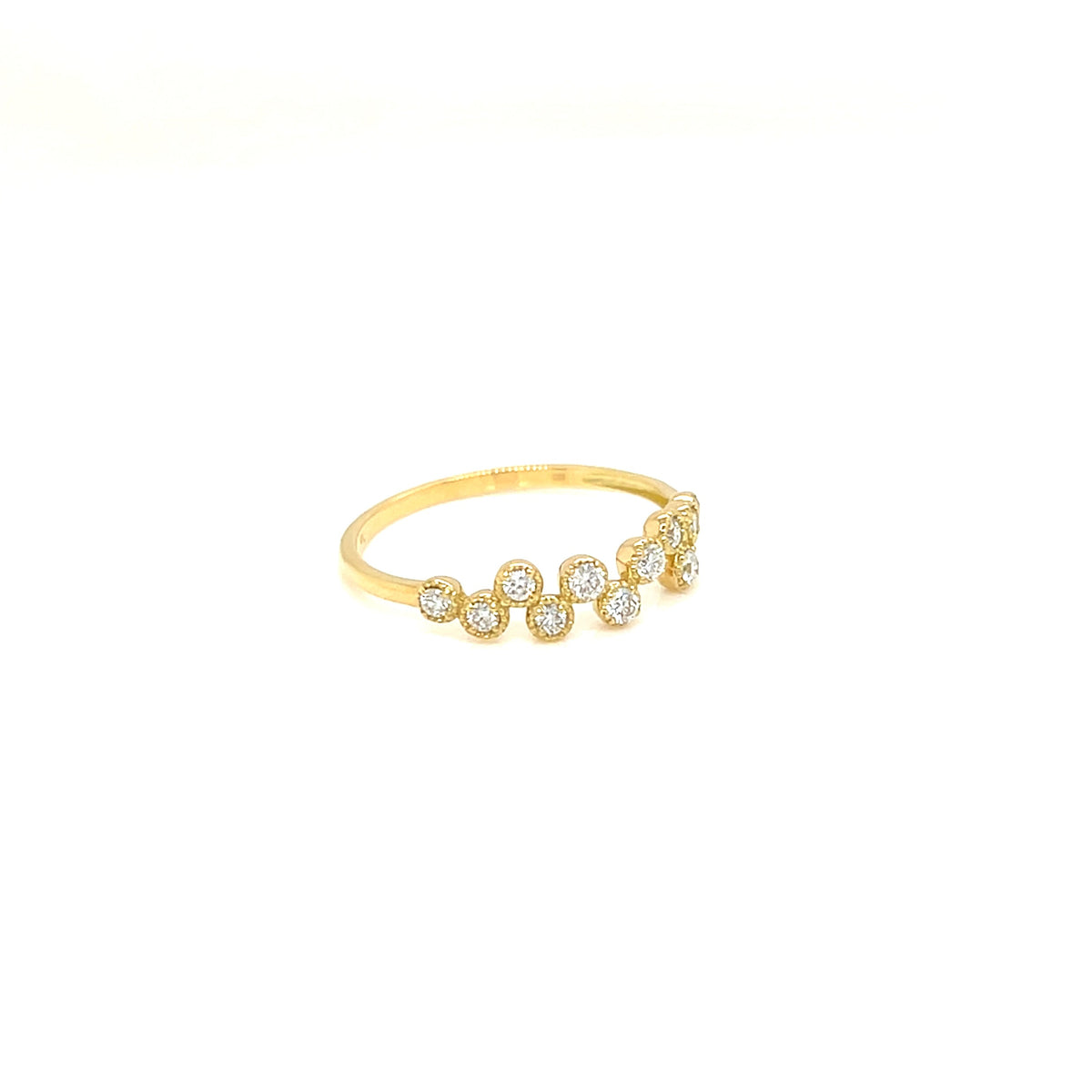 A delicate yellow gold ring featuring a row of small, clear pavé-set round gemstones, photographed against a solid white background.