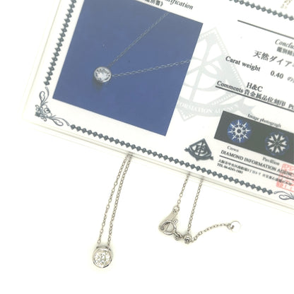 Diamond necklace with chain on a display card with certification details.