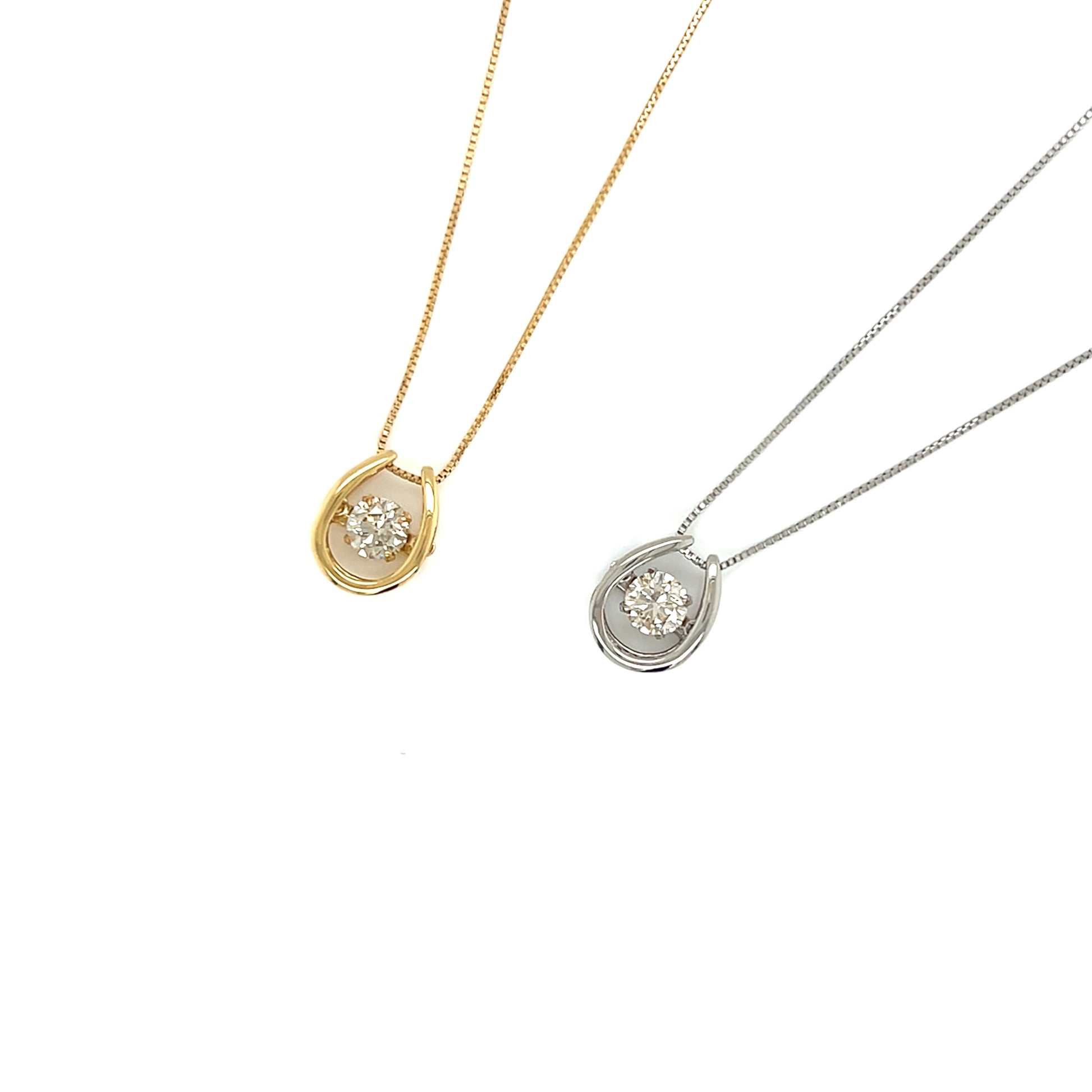Two necklaces with horseshoe-shaped pendants on a white background
