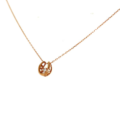 Rose  gold necklace with a small horseshoe pendant on a white background