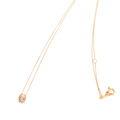 Gold necklace with a small pendant on a white background