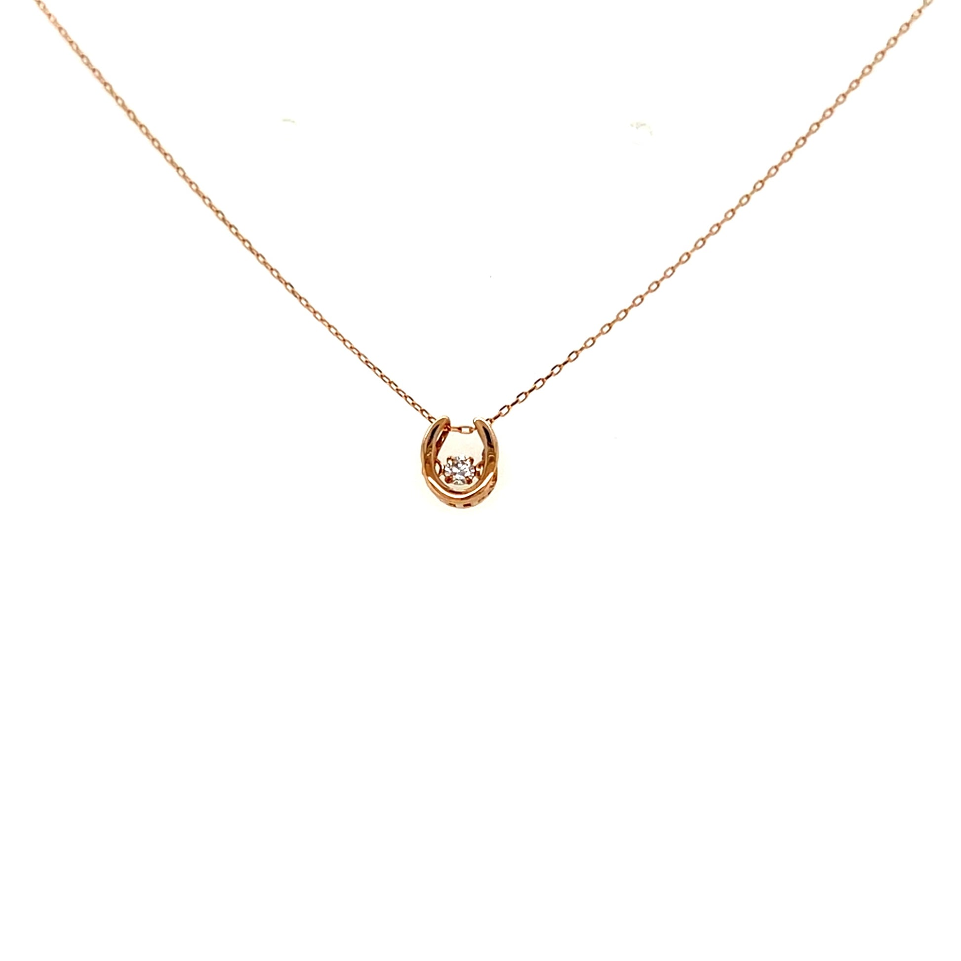 Horseshoe dancing stone gold necklace on a white background