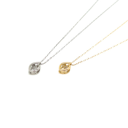 Two delicate leaf-shaped pendant necklaces on fine chains, one in silver and one in yellow gold, both set with small clear stones, displayed on a clean white background.