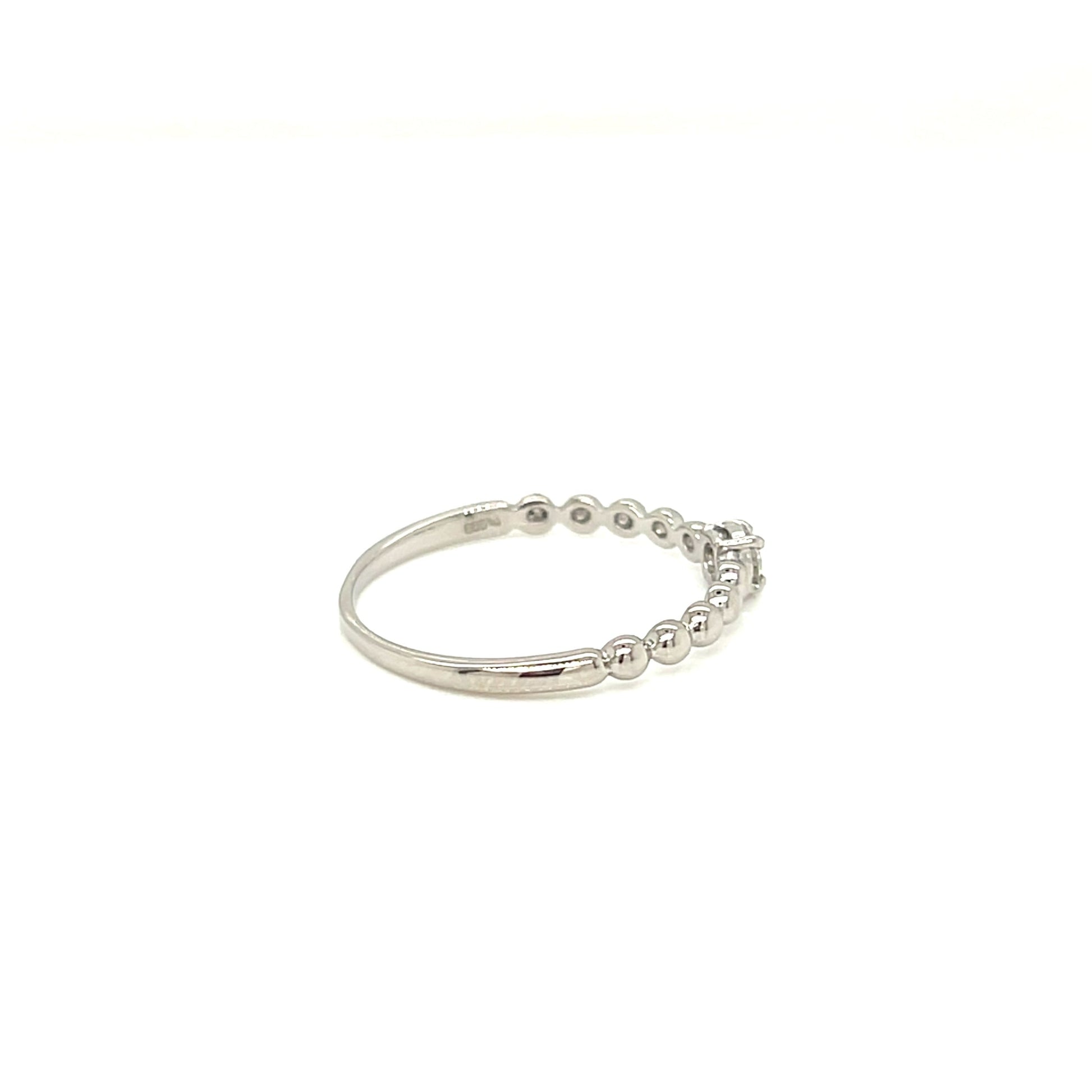 platinum ring with small diamonds on a white backfground.