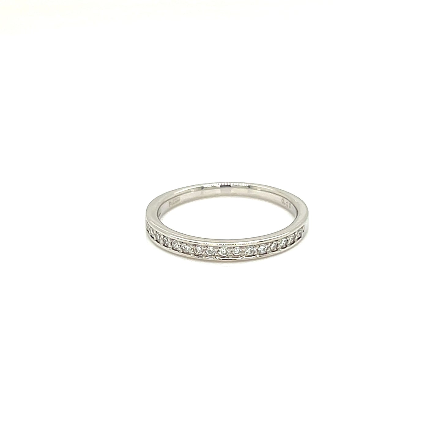 A thin silver band ring with a row of small clear stones set along the front, photographed on a plain white background.
