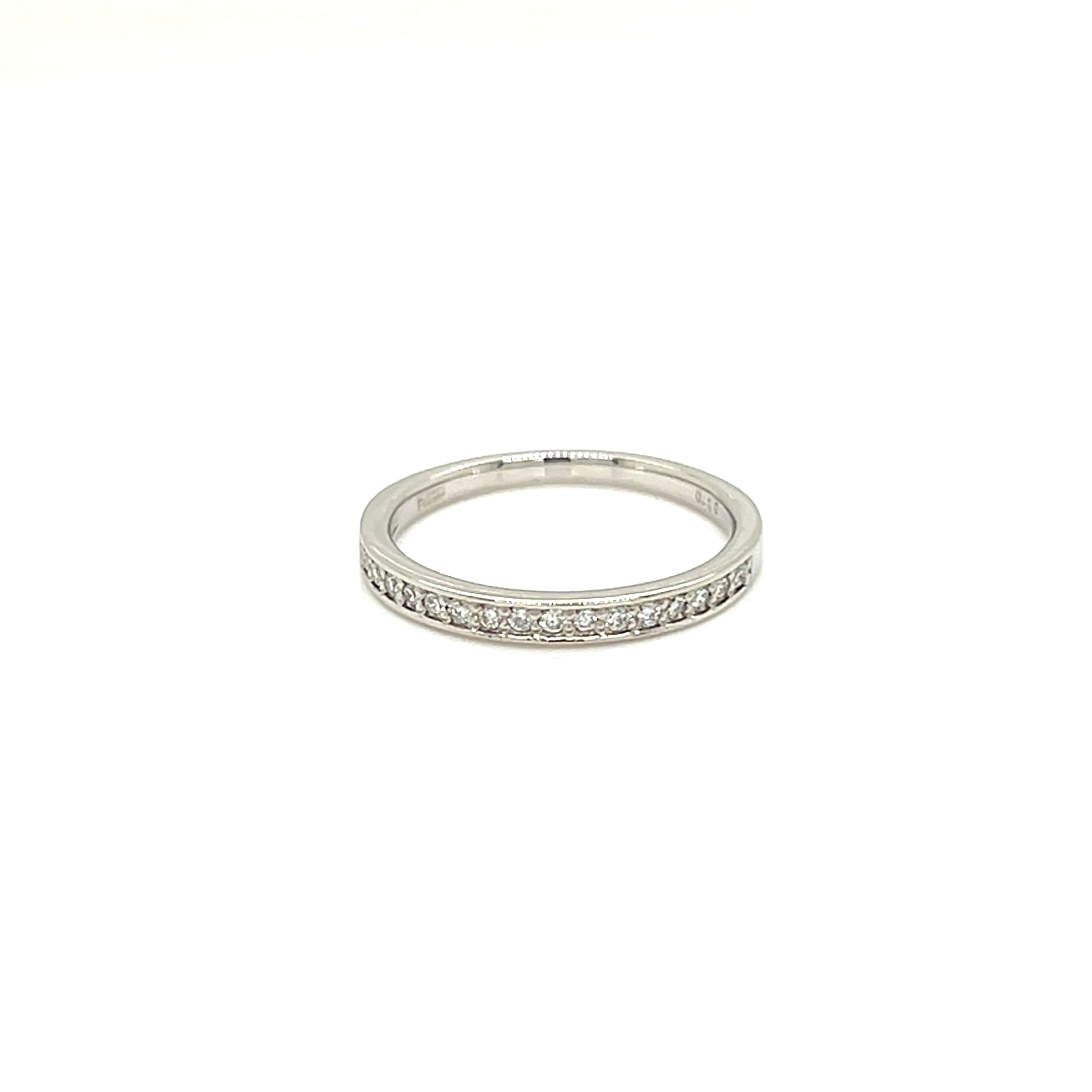 A thin silver band ring with a row of small clear stones set along the front, photographed on a plain white background.