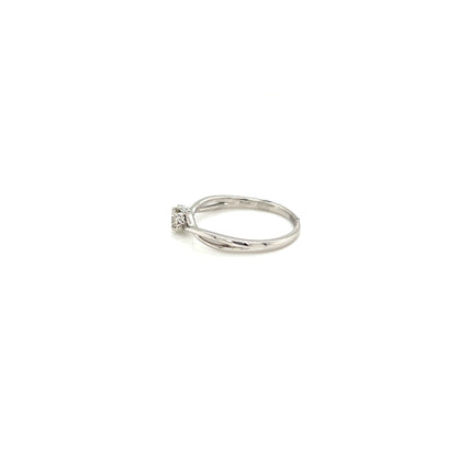 White gold ring with a small diamond on a white background
