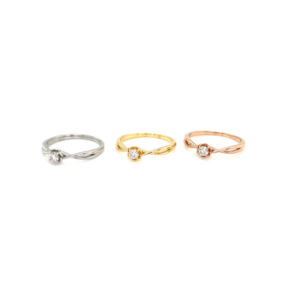 Three rings in white, gold, and rose gold on a white background