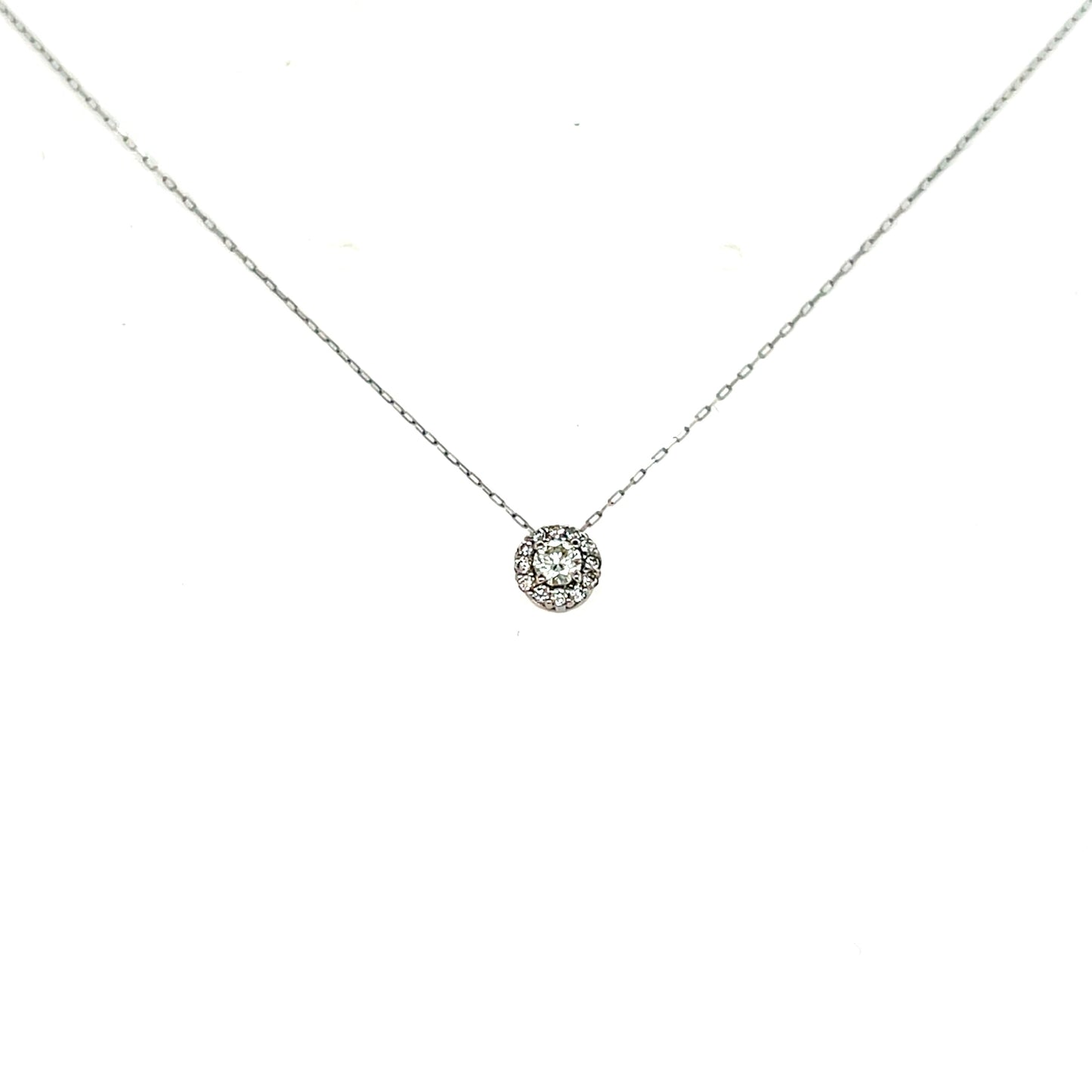 Delicate silver necklace with a small round pendant on a white background