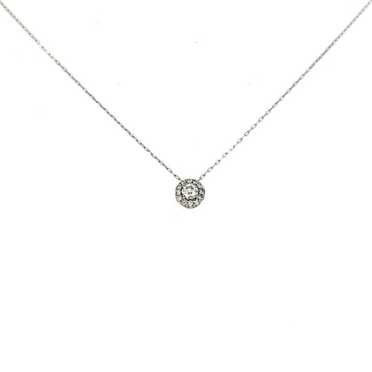 Delicate silver necklace with a small round pendant on a white background