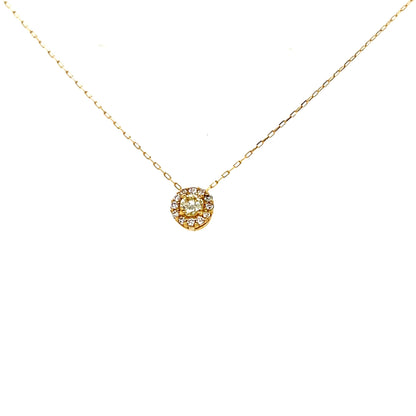 Gold necklace with a round pendant on a white background