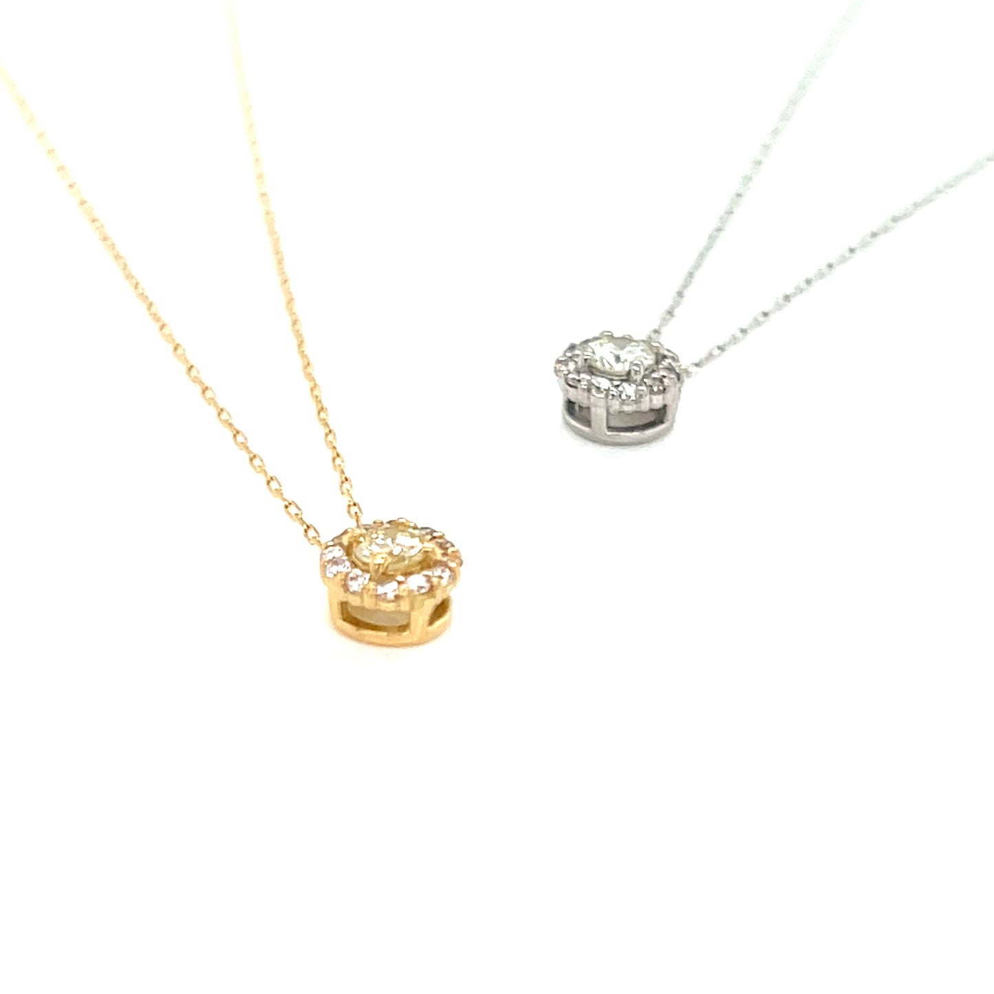 Two gold necklaces with heart-shaped pendants on a white background