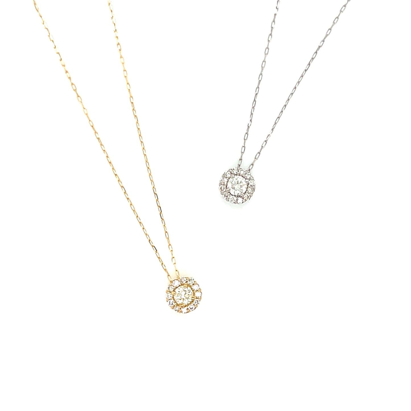 Two gold and platinum necklaces with halo round pendants on a white background
