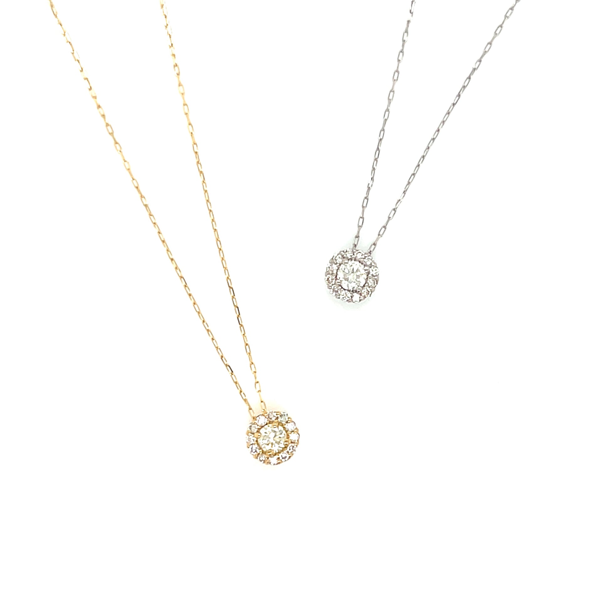 Two gold and platinum necklaces with halo round pendants on a white background