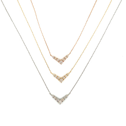 Three gold necklaces with diamond accents on a white background