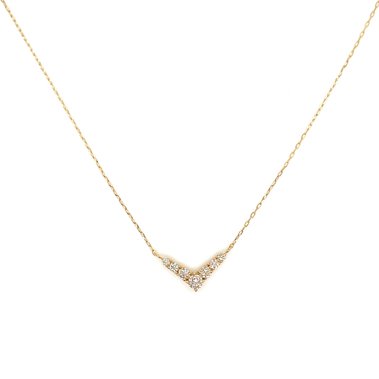 Gold necklace with a small diamond pendant on a white background