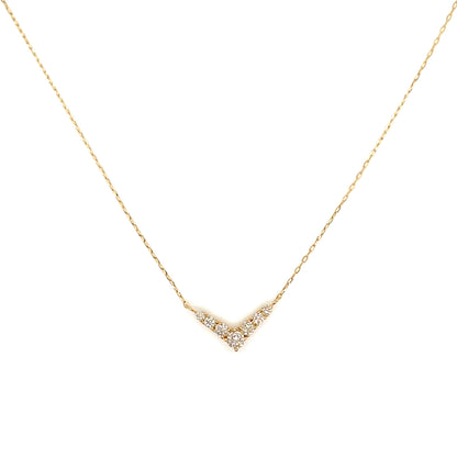 Gold necklace with a small diamond pendant on a white background
