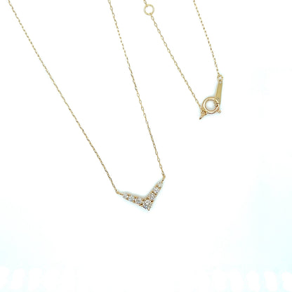 V shape Gold necklace with a small pendant on a white background