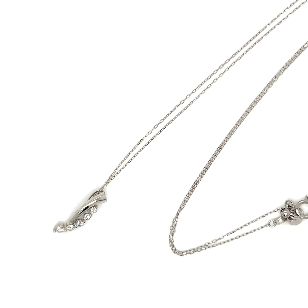 A silver-toned double-strand necklace with a delicate leaf-shaped pendant accented by small clear stones, shown on a plain white background.
