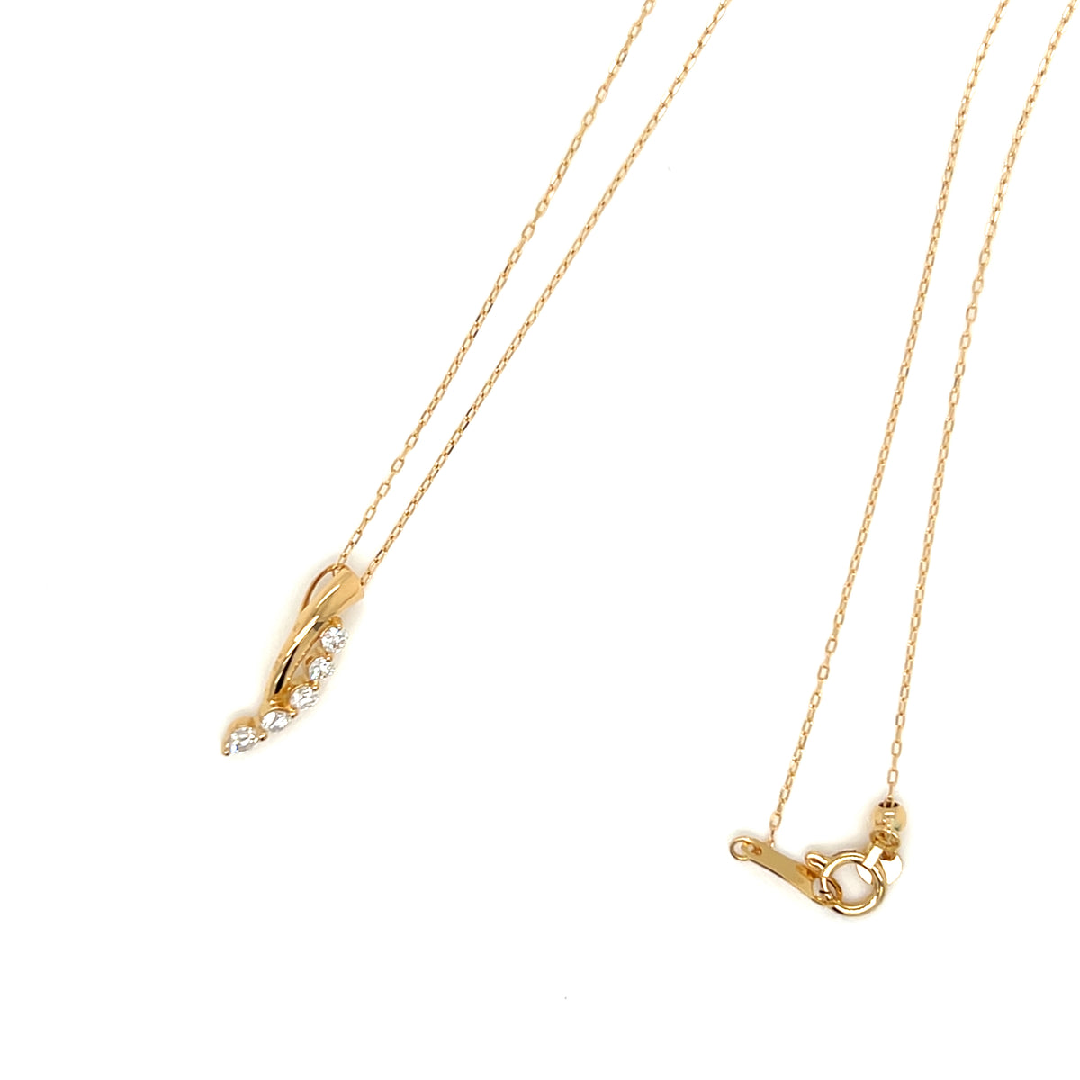 A gold necklace with a delicate chain, featuring a curved pendant adorned with small clear stones on one side and a toggle clasp on the other, displayed on a clean white background.