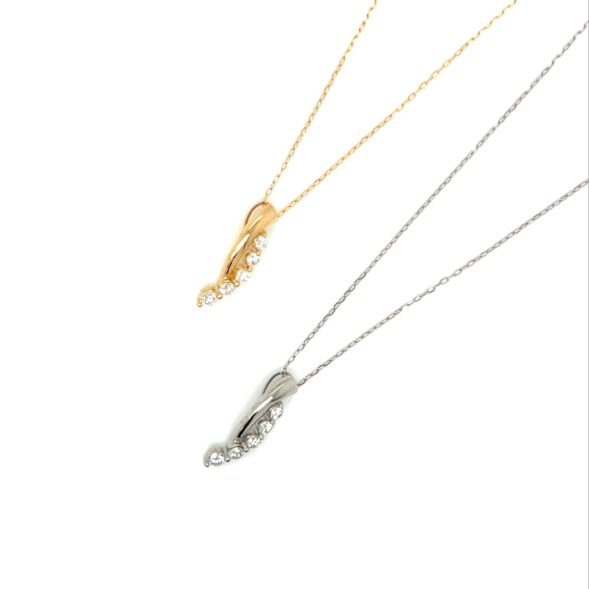 Two delicate necklace pendants on chains, one in yellow gold and one in silver, each featuring a curved openwork pendant set with small clear stones, shown on a plain white background.