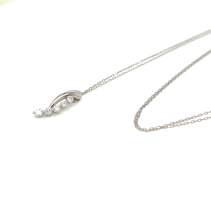 A silver-toned necklace with a delicate chain and a curved pendant featuring small clear gemstones, displayed on a clean white background.